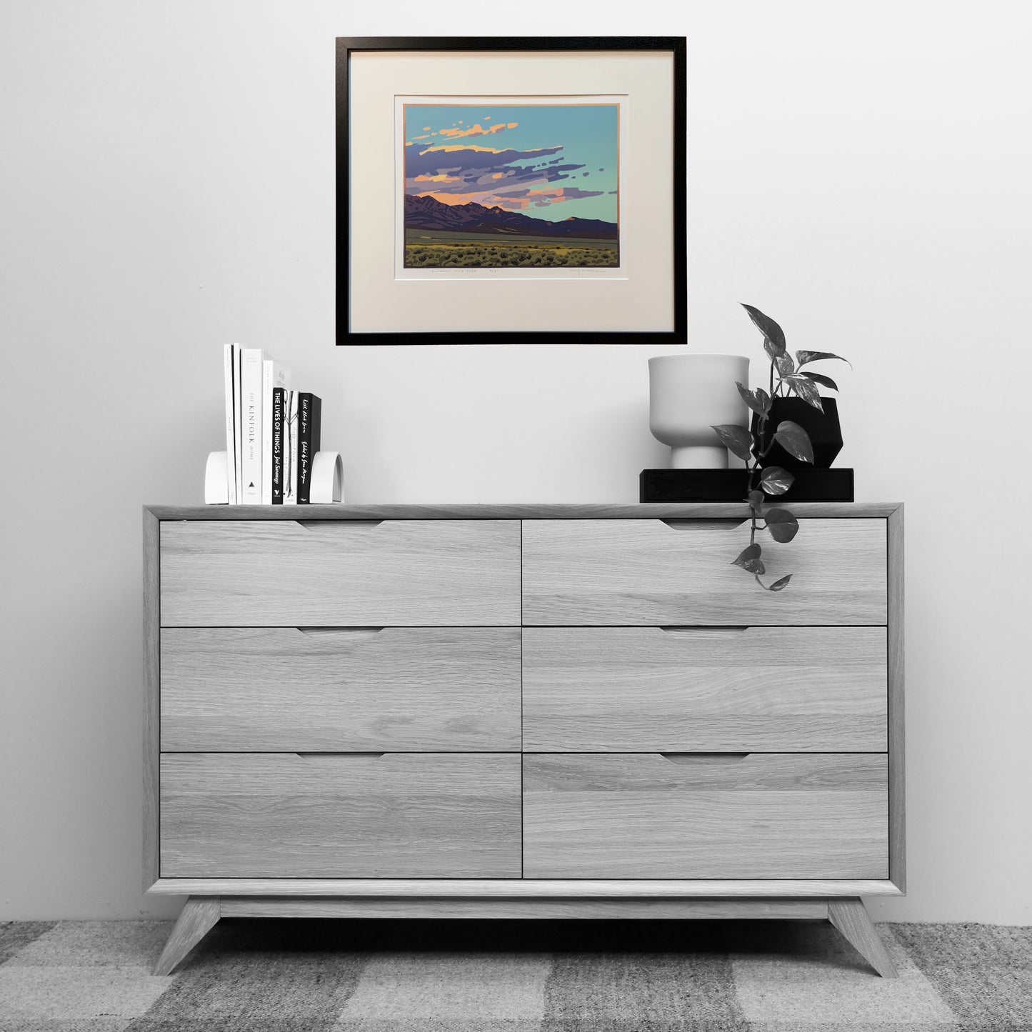 Artwork titled "Sundown and Sage" matted and framed over a dresser for scale