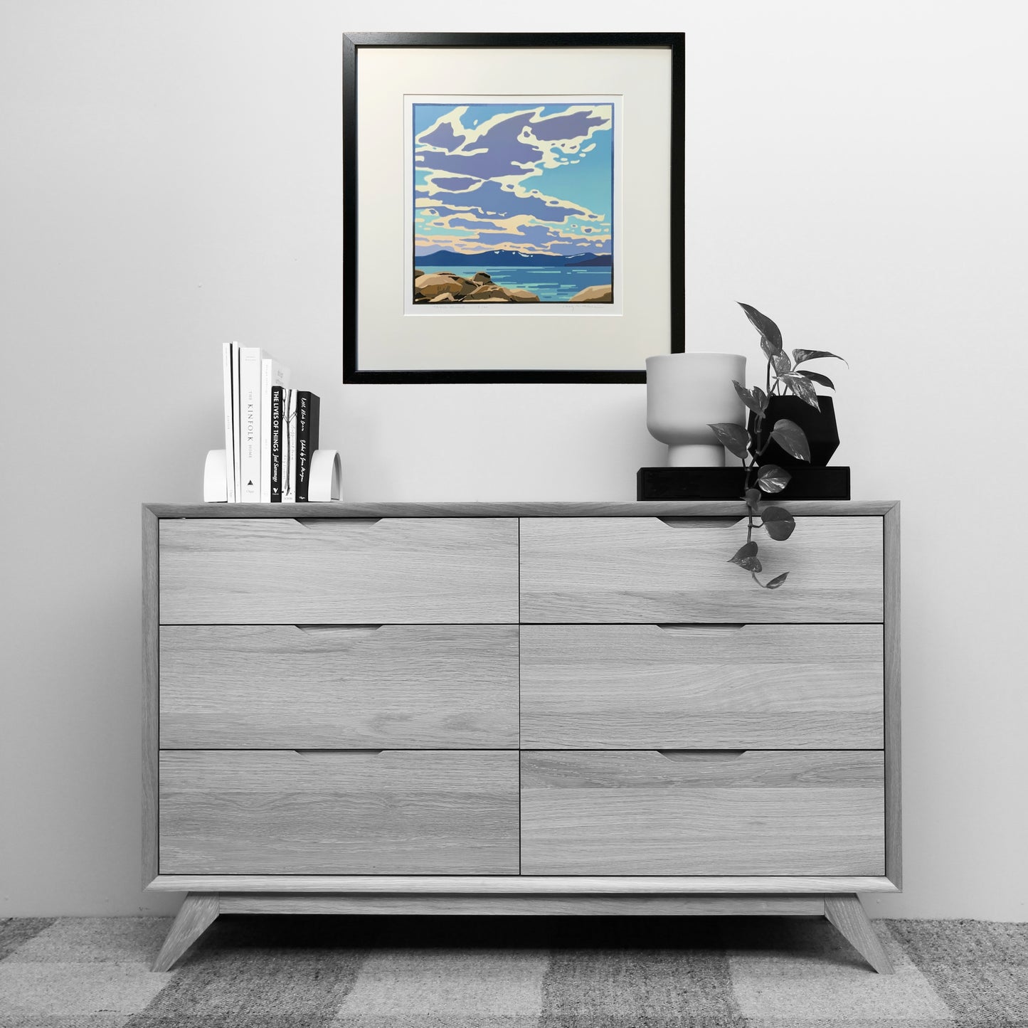 A vibrant Lake Tahoe sky art piece shown above a dresser for scale