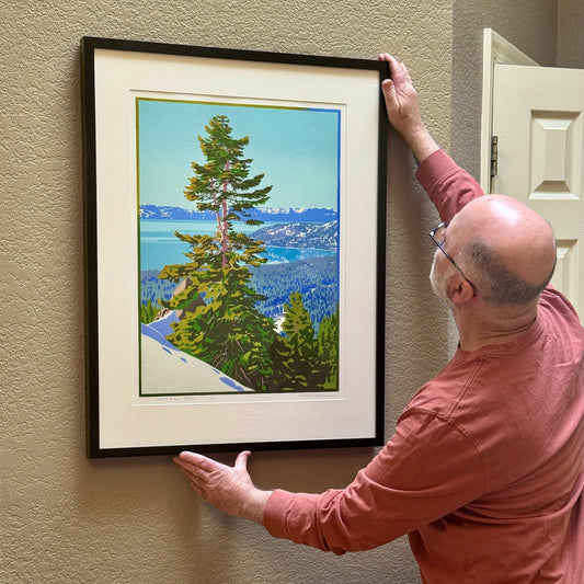Craig Mitchell hanging original Lake Tahoe art on wall