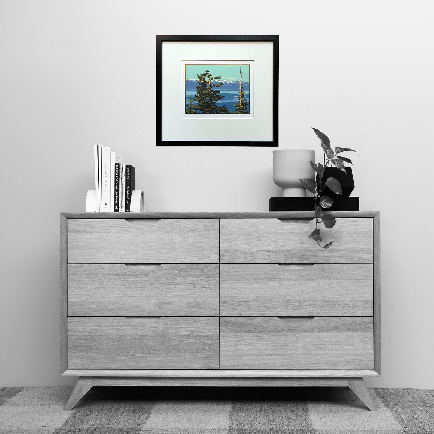 Image of Lake Tahoe artwork with pine trees shown above a dresser for scale