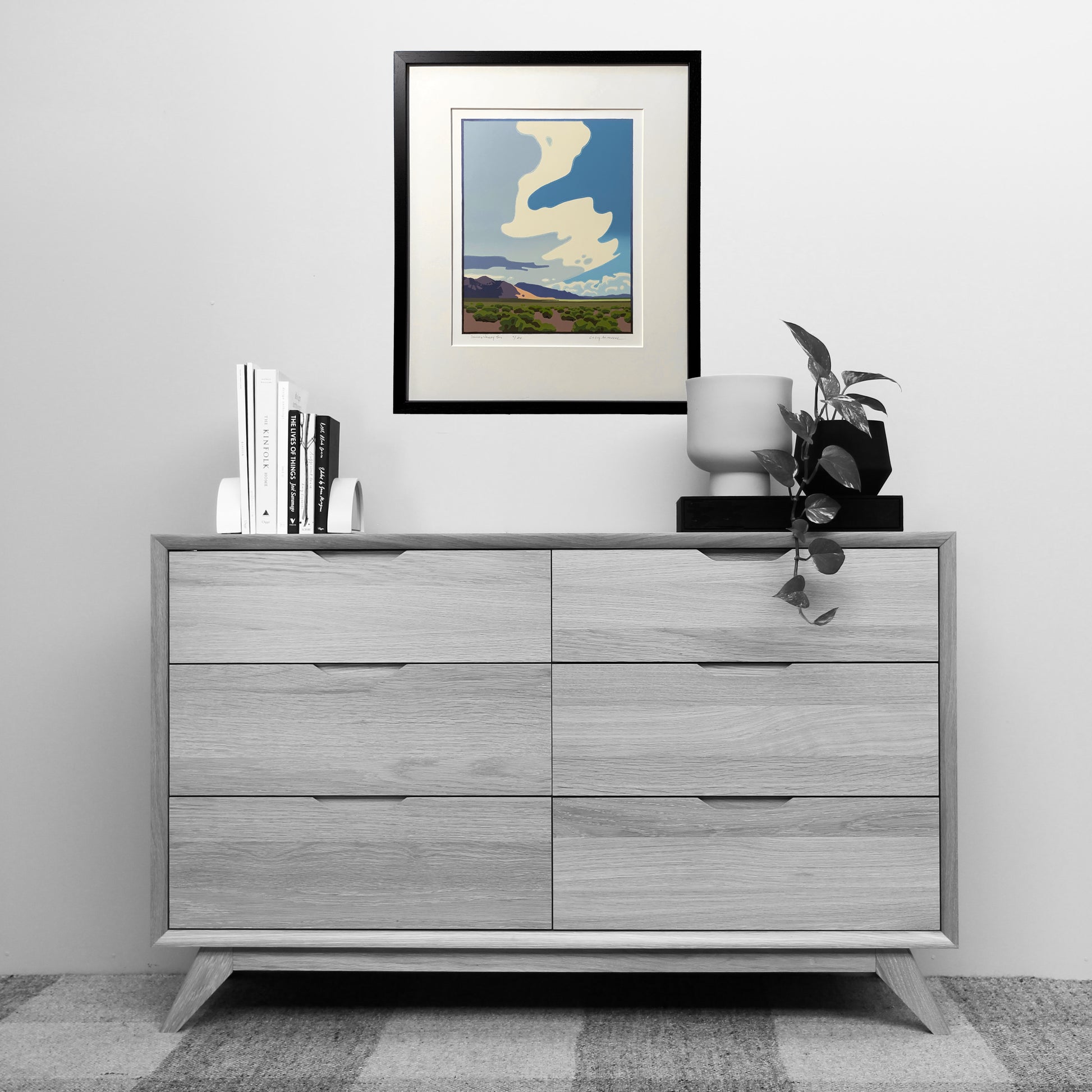 Artwork titled "Smoky Valley Sky" framed and matted hanging over dresser for scale.